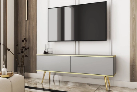 TV-Schrank Luxury 135 cm Korpus in grauem, elegantem Design mit goldener Zierleiste Schrank steht auf goldenen Metallbeinen