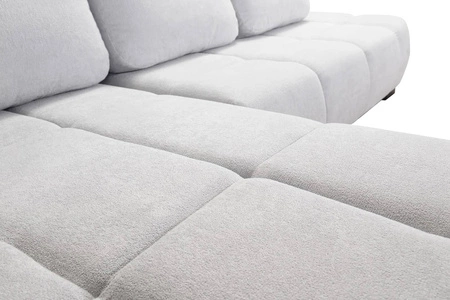 Ecksofa mit Schlaffunktion Zartblaues linksseitiges Ecksofa in stilvollem Design, das sich durch seine abgerundete Form auszeichnet