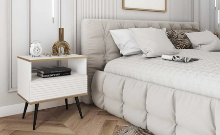 Nachttisch mit Schublade Luxury weiß eleganter Designschrank mit goldener Zierleiste Schrank mit geriffelter Front schwarze hohe Beine